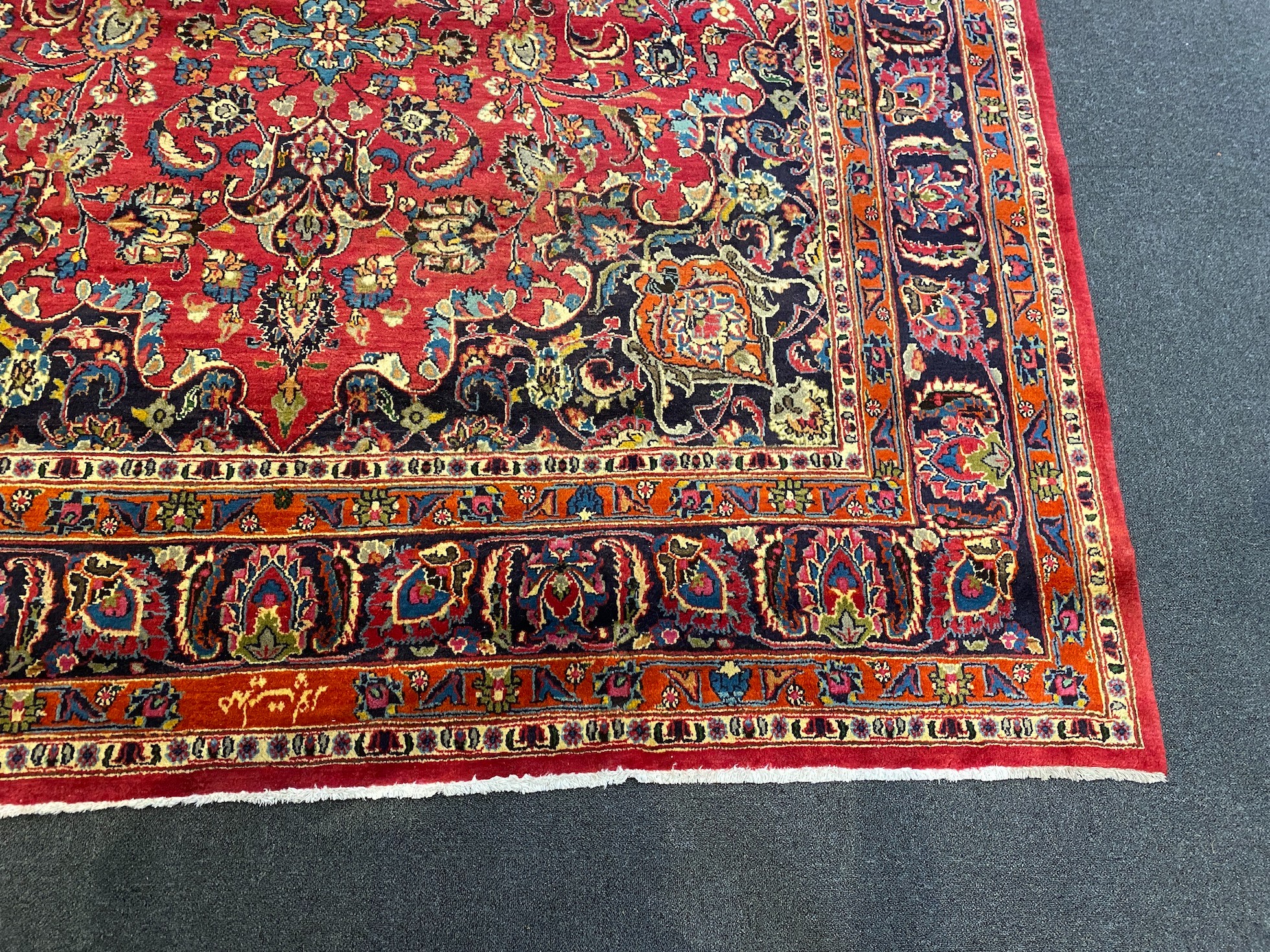 A Kashan claret ground carpet, 375cm x 250cm